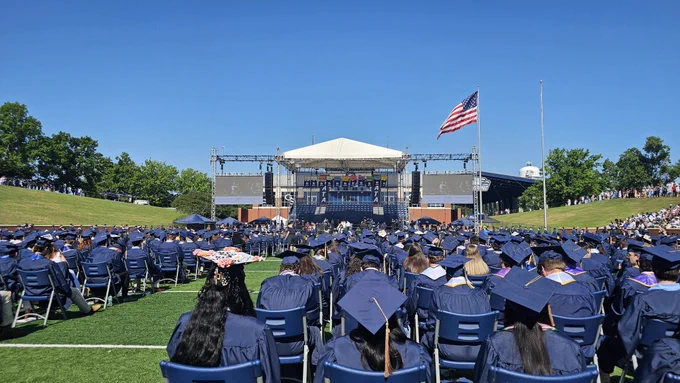 A large group of graduates sitting at a commencement ceremony at Allen E. Paulson Stadium.