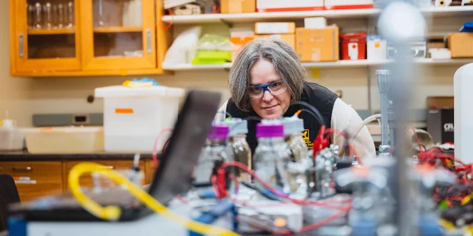 Michigan Tech professor Amy Marcarelli observes sensor prototypes in a lab. 