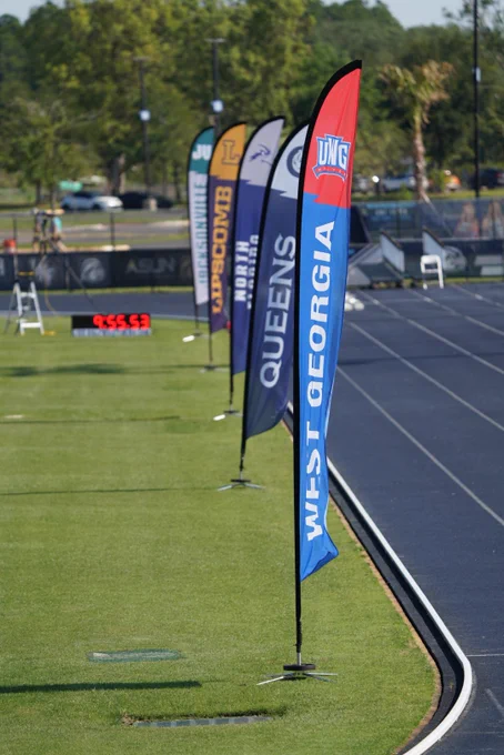 The flags of each school in the ASUN planted in the ground at the outdoor track championship