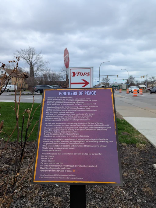 Memorial sign located at the Tops Friendly Market on Jefferson Avenue featuring a poem titled "Fortress of Peace" written by A. Fareed-Cooke.