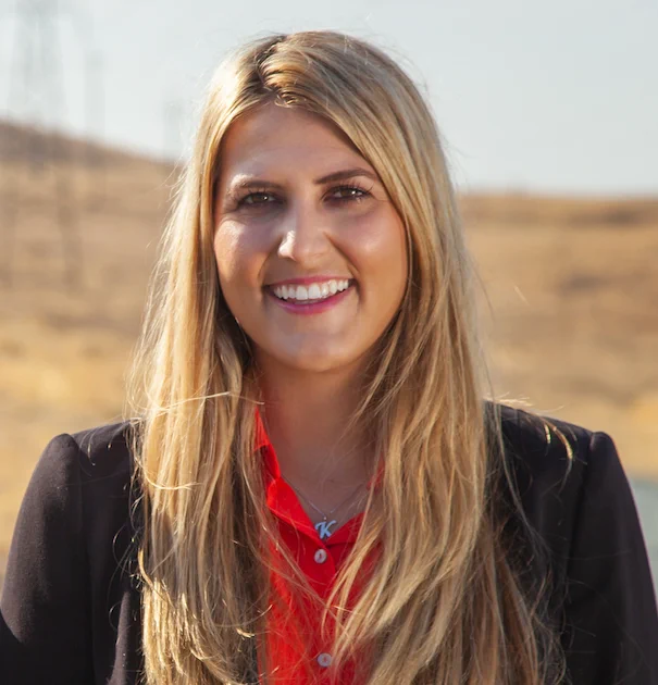 Headshot of Kaitlyn Albertoli in an open field