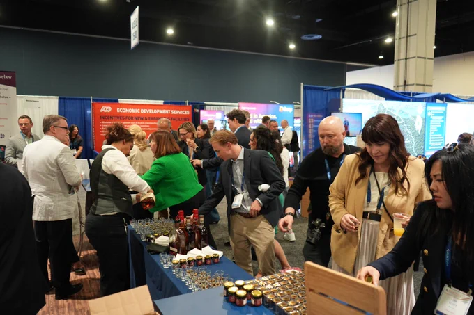 People taking samples of bourbon and bourbon balls in business attire