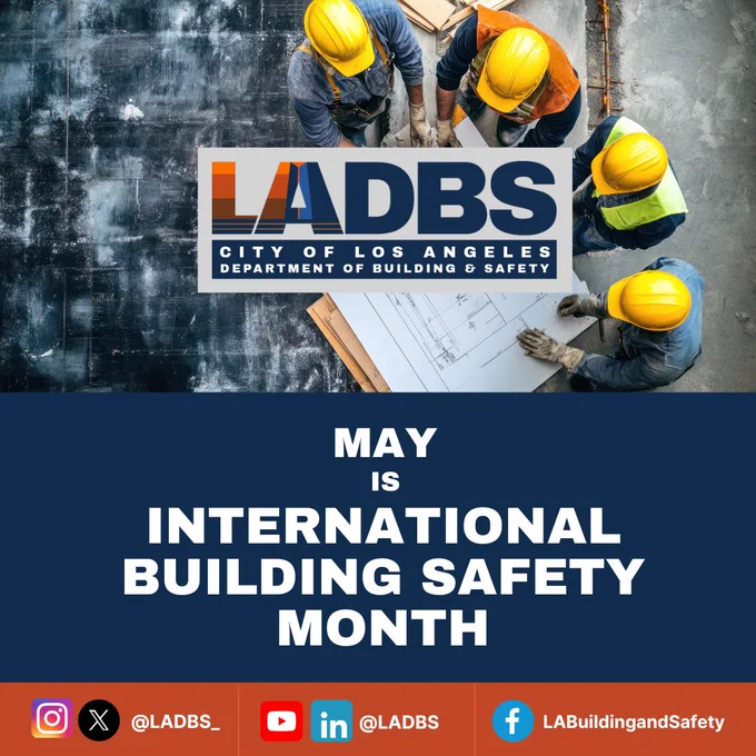 Graphic for LADBS promoting International Building Safety Month in May. The image shows an overhead view of construction workers wearing yellow hard hats reviewing blueprints at a job site. Centered is the LADBS (City of Los Angeles Department of Building and Safety) logo. Large white text reads: “May is International Building Safety Month.” Along the bottom are LADBS social media icons and handles for Instagram/X (@LADBS_), YouTube/LinkedIn (@LADBS), and Facebook (LABuildingandSafety).