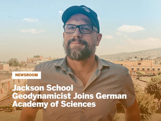 Thorsten Becker wearing a cap and buttoned shirt stands outdoors with a cityscape and hills in the background under a partly cloudy sky with headline "Jackson School Geodynamicist Joins German Academy of Sciences"