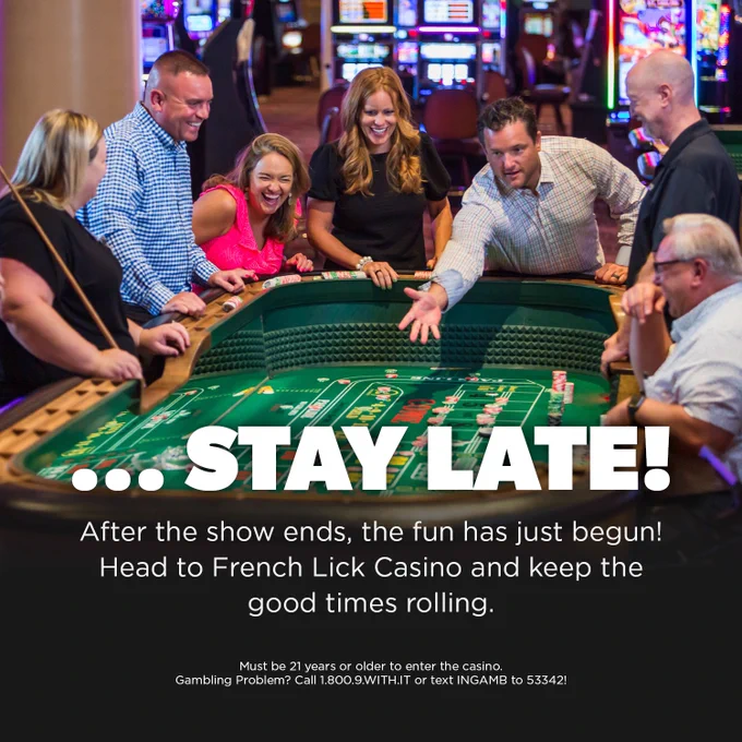A group of people enjoying a game at a craps table inside French Lick Casino. The atmosphere is lively, with bright lights and gaming machines in the background. Text on the image encourages staying late for continued fun.