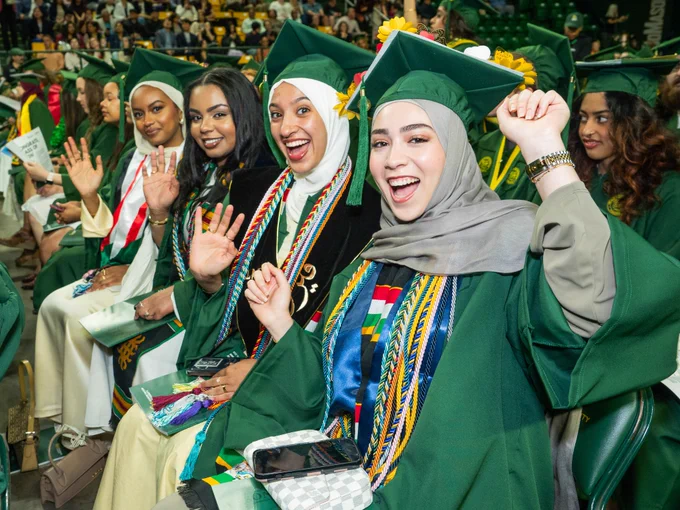 Graduates celebrate before the 2026 Spring Commencement at EagleBank Arena.     Photo by Andani Munkaila/Creative Services/George Mason University