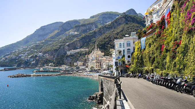Capture the breathtaking beauty of the Amalfi Coast with its stunning cliffs and vibrant waters.