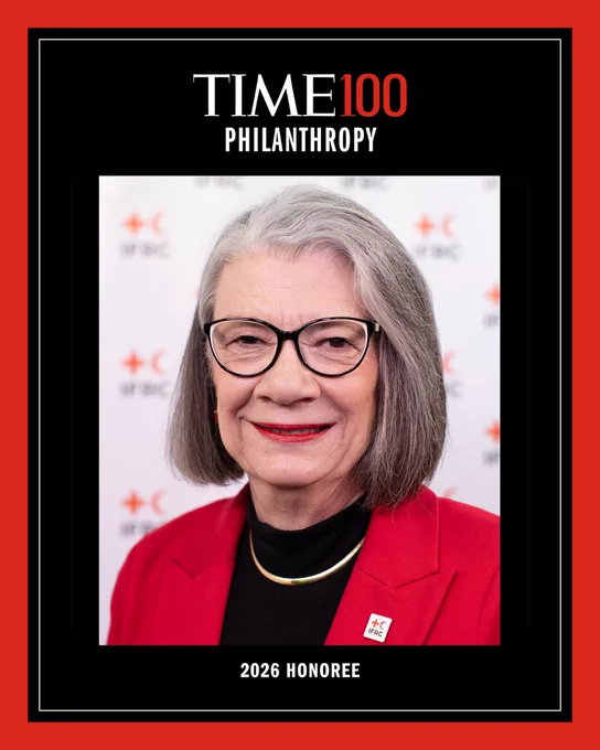 This is the cover of a Time 100 Philanthropy issue, featuring a person with glasses and gray hair wearing a red blazer. The background displays logos with a red cross and crescent. The text reads "2026 Honoree.
