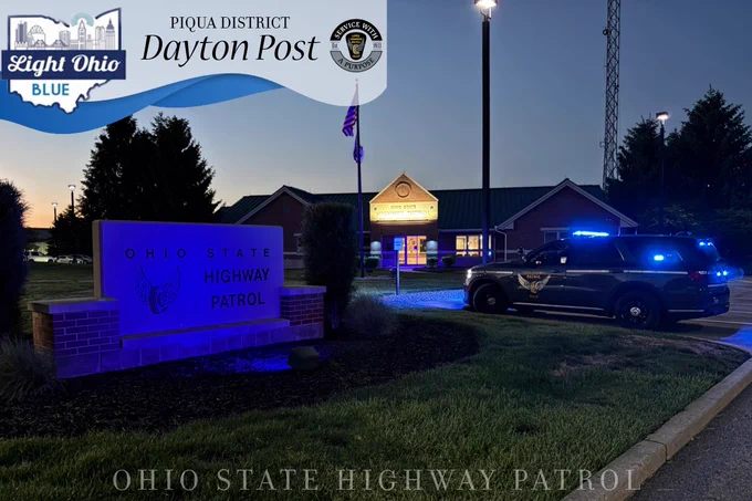 The Dayton Patrol Post lit up with blue lights in honor of National Police Week. A Durango is parked off to the side. 
