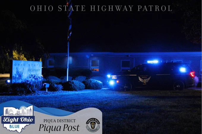 The Piqua Patrol Post lit up with blue lights in honor of National Police Week. A Durango is parked off to the side. 