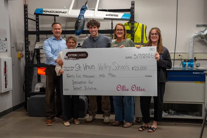 5 people pose with the large check 