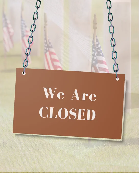 "We are closed" sign over a field of American flags. 