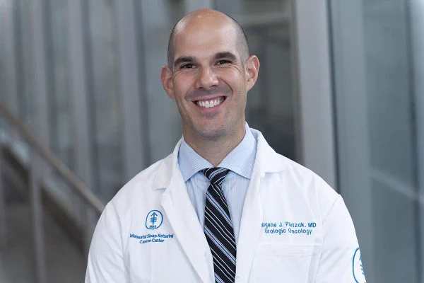 Image of Dr. Eugene Pietzak smiling in his white lab coat.