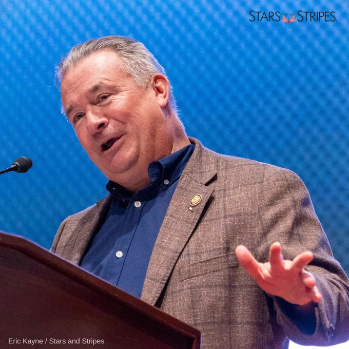 Congressman Don Bacon (R-NE) speaks at a podium with a blue screen in the background. (Eric Kayne/Stars and Stripes)