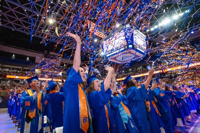 Boise State students celebrating graduating at the Spring 2026 commencement in Extra Mile Arena. 