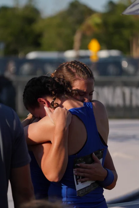two girls hugging after carleigh bynum wins gold