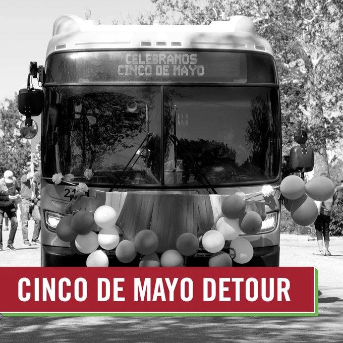 A black and white image of a Metro Transit bus decorated with balloons and a sign reading 'Celebramos Cinco de Mayo' during a festive detour event. A banner at the bottom reads "cinco de mayo detour"