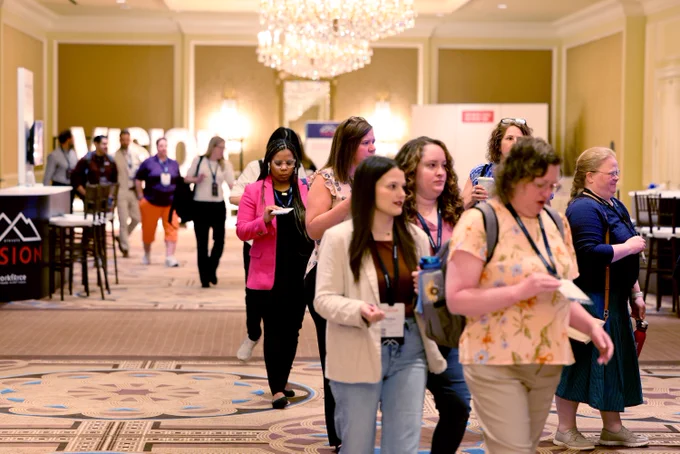 Attendees in line filing into closing session