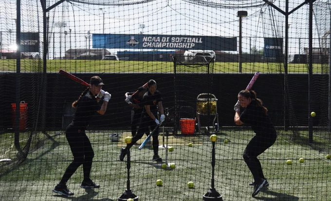 Players take swings in the batting cage
