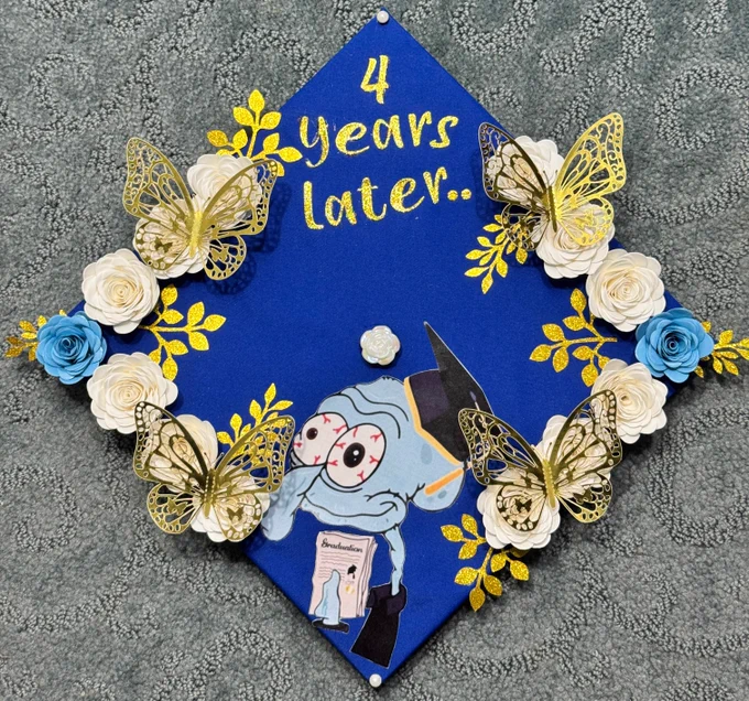 A graduation cap decorated with flowers, butterflies, Squidward holding a diploma, and the words \"4 years later\".