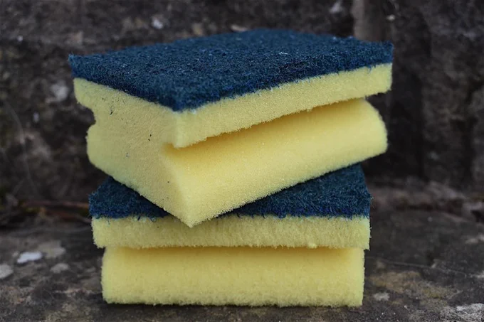 Two yellow and green plastic kitchen sponges