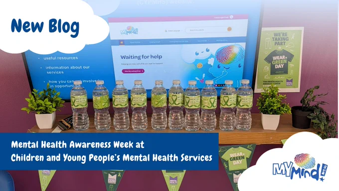 A picture of a waiting room tv. In front of it is a shelf with Wear It Green branded water bottles and Wear It Green bunting along the bottom of the shelf. The text says, "New Blog. Mental Health Awareness Week at Children and Young People's Mental Health Services. MyMind."