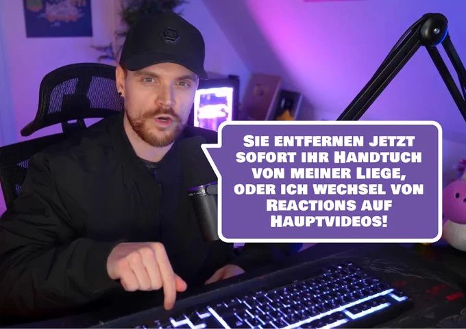 Bild von iBlali aus einem Video. Er spricht, blickt ernst und zeigt mit dem Finger auf den Tisch. Sprechblase "Sie entfernen jetzt sofort ihr Handtuch von meiner Liege, oder ich wechsel von Reactions auf Hauptvideos!"