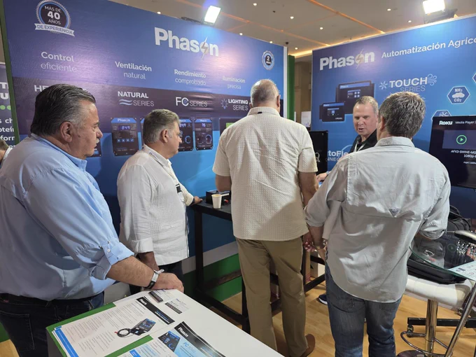 Joel from Phason Controls speaking with attendees at the Phason booth during Opormex 2026 while showcasing ventilation and farm automation controls.