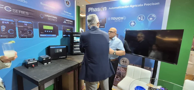 Stephen from Phason Controls demonstrating Touch Series and AutoFlex Connect control systems to a visitor at Booth 14 during Opormex 2026.