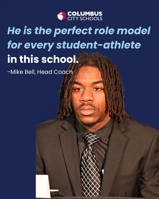 A person with long textured hair is wearing a suit and tie, sitting at a table. The background includes text that reads, "He is the perfect role model for every student-athlete in this school." At the top, the logo and name "Columbus City Schools" are displayed in red and white.