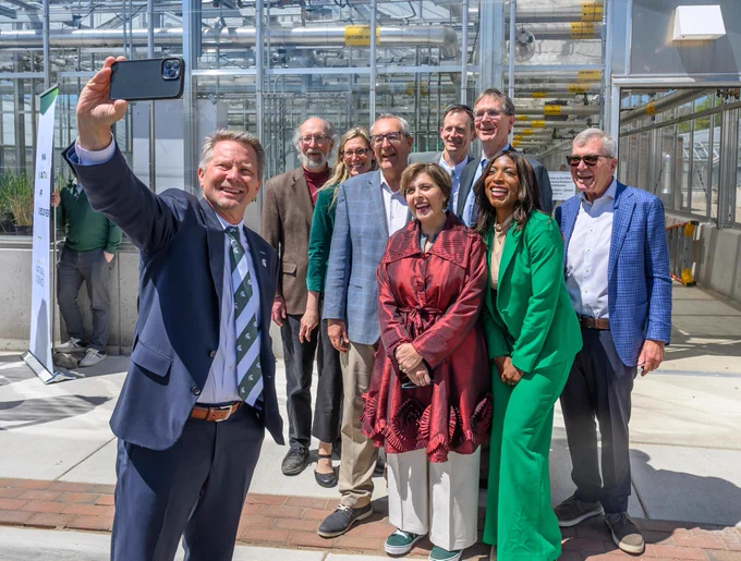 President Guskiewicz taking selfie at MSU Greenhouse Renovation Ribbon-cutting.