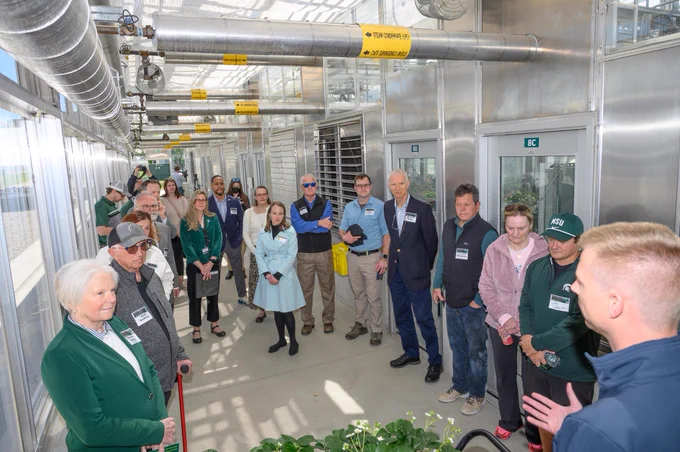 President Guskiewicz with group on tour at MSU Greenhouse Renovation Ribbon-cutting.