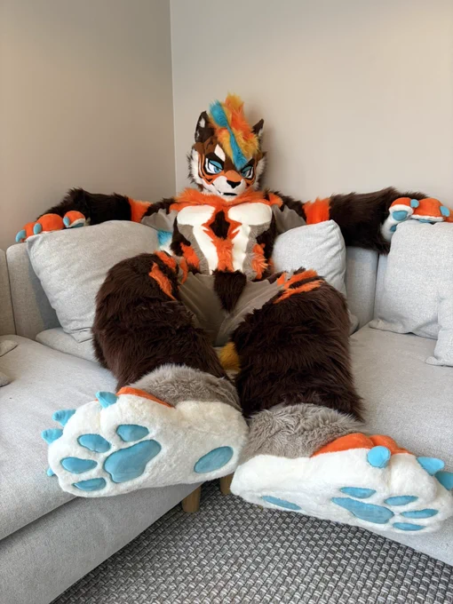 Fursuiter lounging on the couch for fursuit Friday