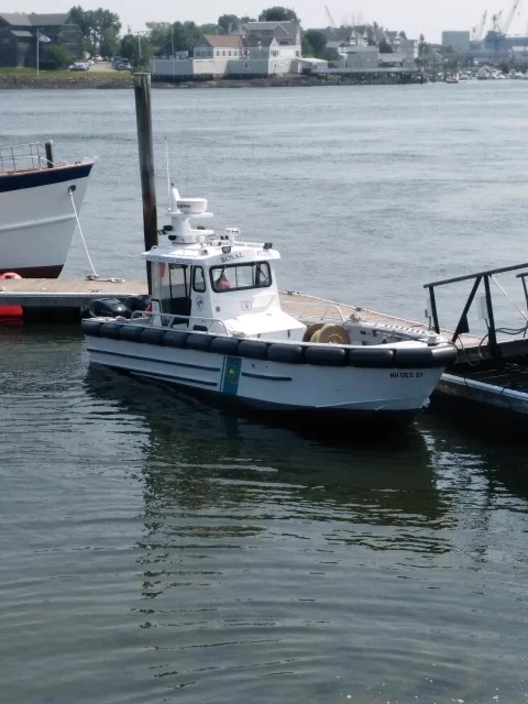 A boat named the "Royal Flush" sits at a dock.