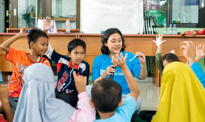 Volunteers support well-being in communities across the world. Photo from Indonesia referenced in 2026 SWVR.
