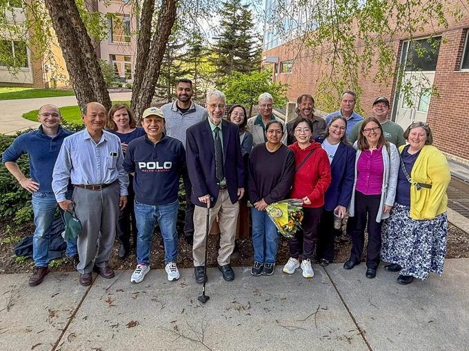 Dr. Bob Hausinger stands with former lab members after delivering his seminar. 