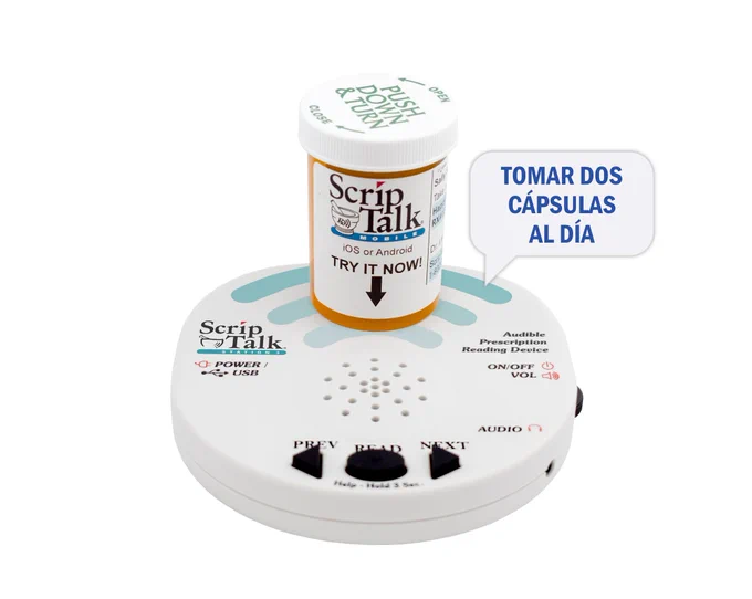 A ScripTalk Station Reader with a prescription bottle on top. A talking bubble is coming out saying take one capsule a day in Spanish.