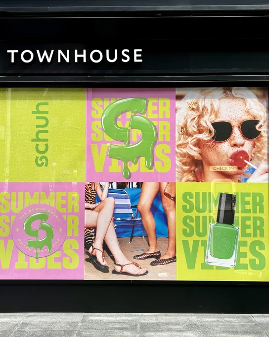 An image of multiple schuh posters covering a window of Townhouse Liverpool Street.