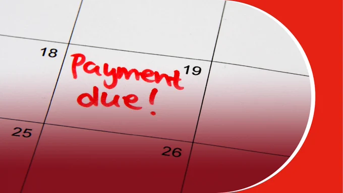 Calendar close-up showing 'Payment due!' written in red on the 19th day.