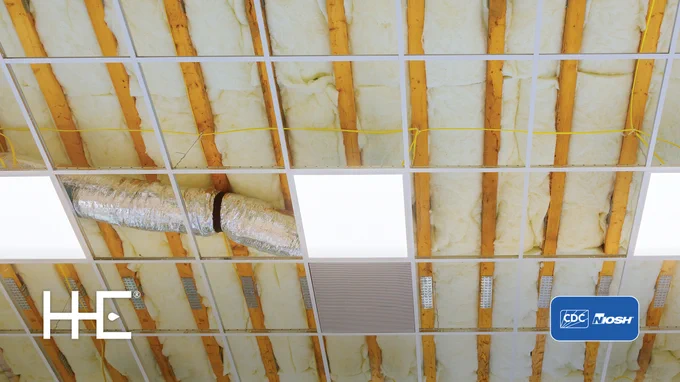 photo shot looking up at a ceiling that isn't finished but has insulation showing with the HHE and CDC/NIOSH logos