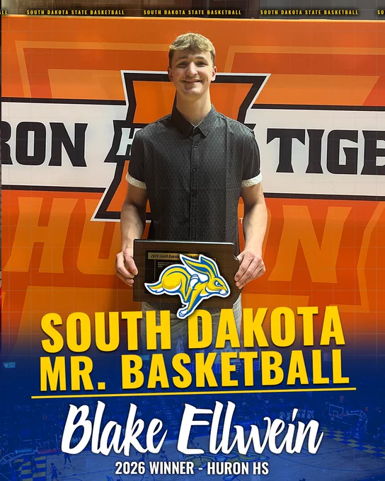 A basketball-themed award graphic shows a person standing in front of a bright orange wall with South Dakota State basketball branding. The person is holding a rectangular plaque. Large overlaid text reads “South Dakota Mr. Basketball,” with a blue-and-yellow jackrabbit logo centered above the words. Below, stylized script text reads “Blake Elwein,” and smaller text at the bottom reads “2026 Winner – Huron HS.” The lower portion of the image features a faded basketball court background in blue tones.