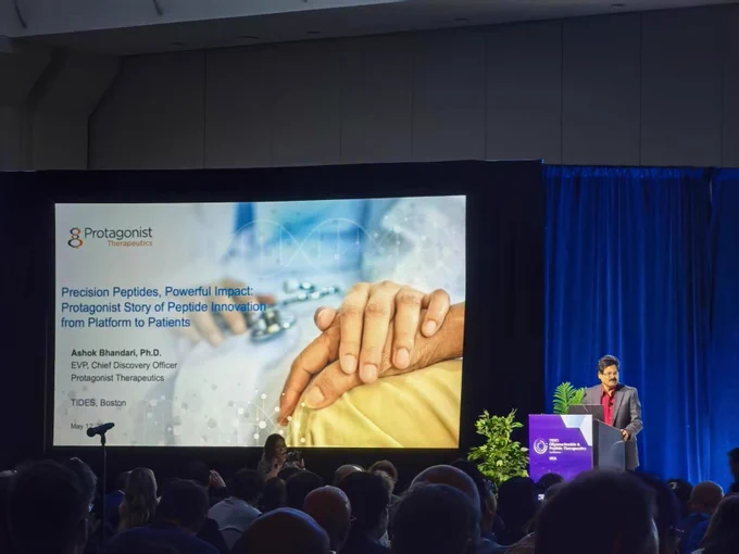 EVP, Chief Discovery Officer Ashok Bhandari presenting at TIDES USA alongside title slide which says, “Precision Peptides, Powerful Impact: Protagonist Story of Peptide Innovation from Platform to Patients”