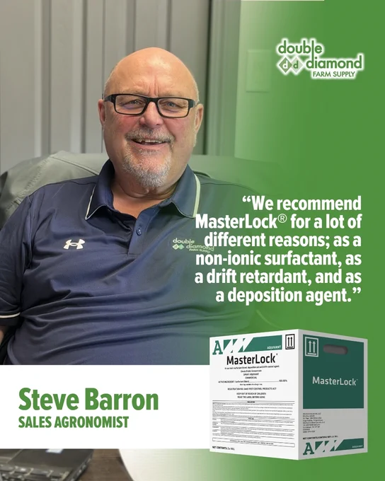 This image shows a person sitting in an office chair, smiling. They are wearing glasses and a polo shirt. Next to them is a large graphic with text reading: "We recommend MasterLock® for a lot of different reasons; as a non-ionic surfactant, as a drift retardant, and as a deposition agent." The name Steve Barron and the title Sales Agronomist are displayed, along with the Double Diamond Farm Supply logo. At the bottom right is an image of a MasterLock® product box.