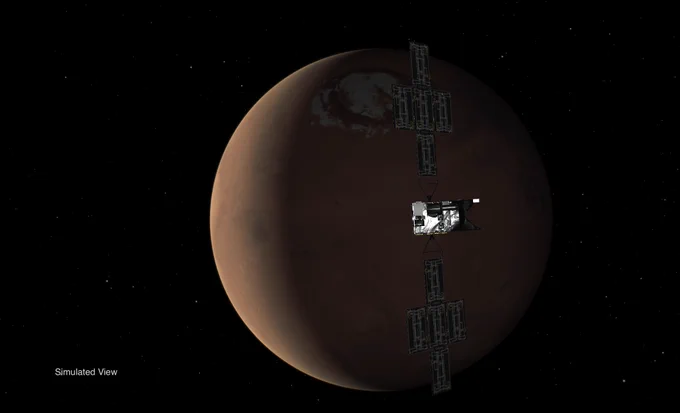 Simulated view of the Psyche spacecraft, with its "wings" of solar panel arrays, approaching the planet Mars, seen in crescent phase.