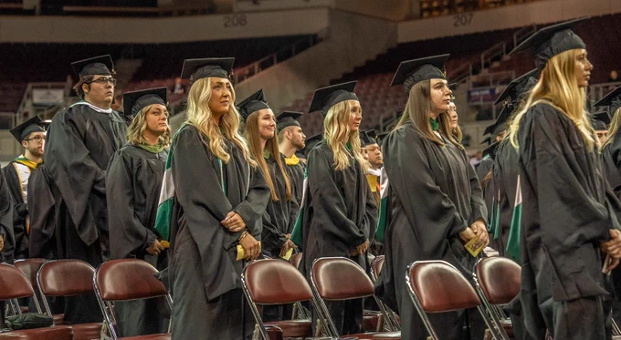 Graduates standing at attention