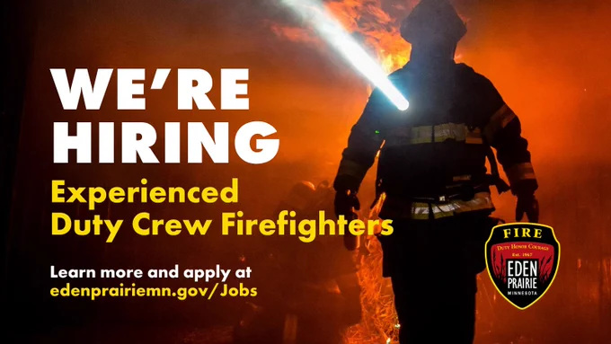 Firefighter in full gear amid flames with text announcing hiring for experienced duty crew firefighters in Eden Prairie.
