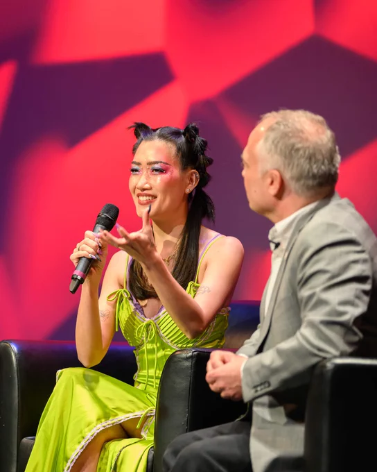 Jenny Heijun Wills speaks into a microphone on stage. 