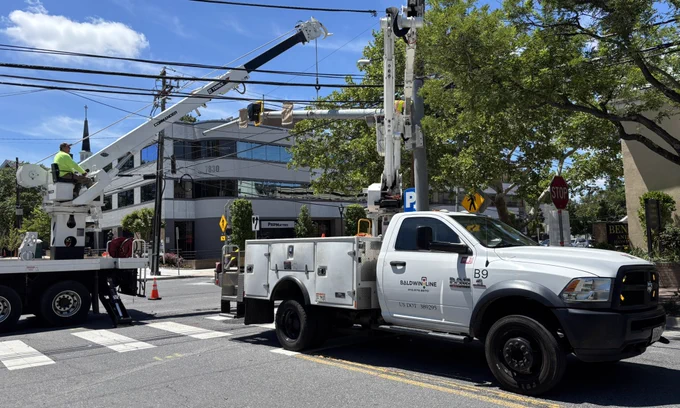 Crews install HAWK crosswalk signals above Northbound Old Georgetown Road (MD-187) at Cordell Avenue in Bethesda, Maryland.