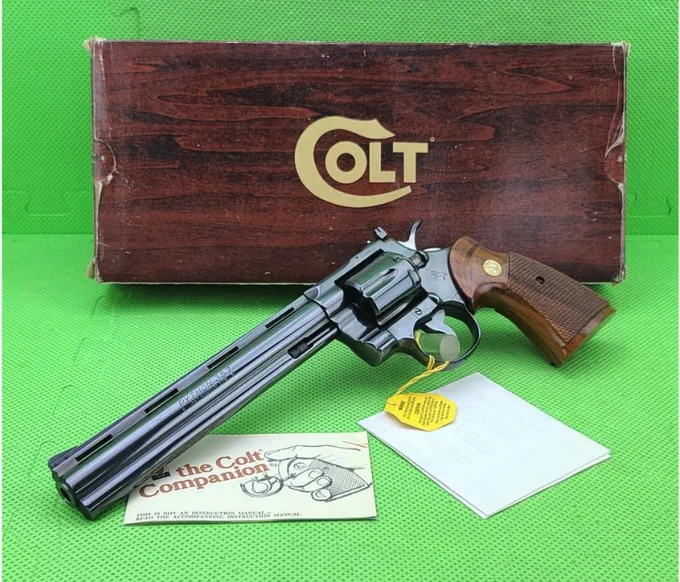 🔥 1980 Colt Python 8-inch Royal Blue  
🔗 Take a closer look: https://bit.ly/4eOSjtJ
This rare 1980 Colt Python in .357 Magnum features factory 8-inch barrel, deep Royal Blue finish, ventilated rib full lug barrel, checkered walnut target grips with gold medallions, and includes the original wood grain box, manual, and hangtag. 

#ColtPython #357Mag #Gunsdaily 
