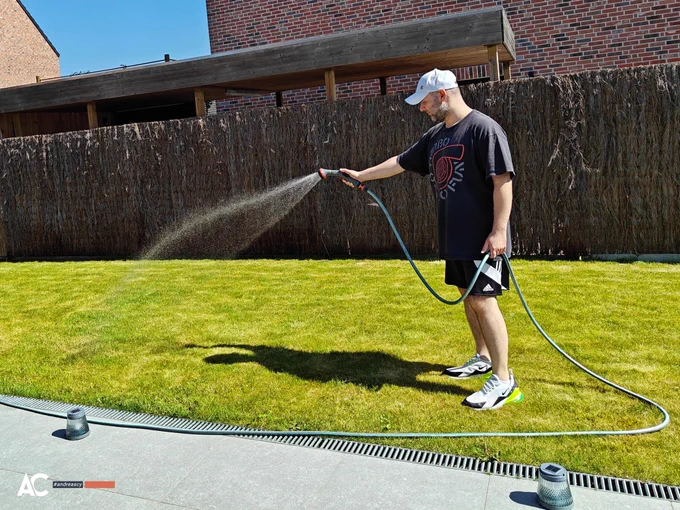 Andreas Christodoulou waters his lawn